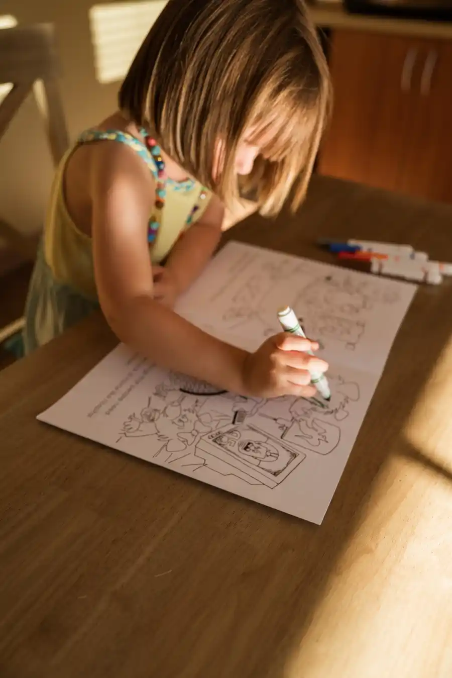 Young girl coloring a picture at home