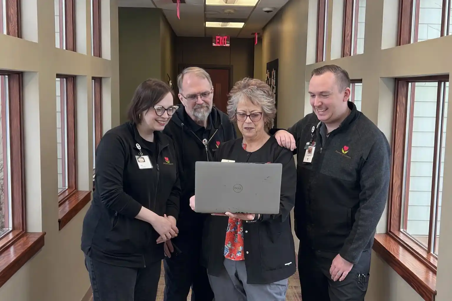Four Hospice of Lenawee staff members looking at a laptop together